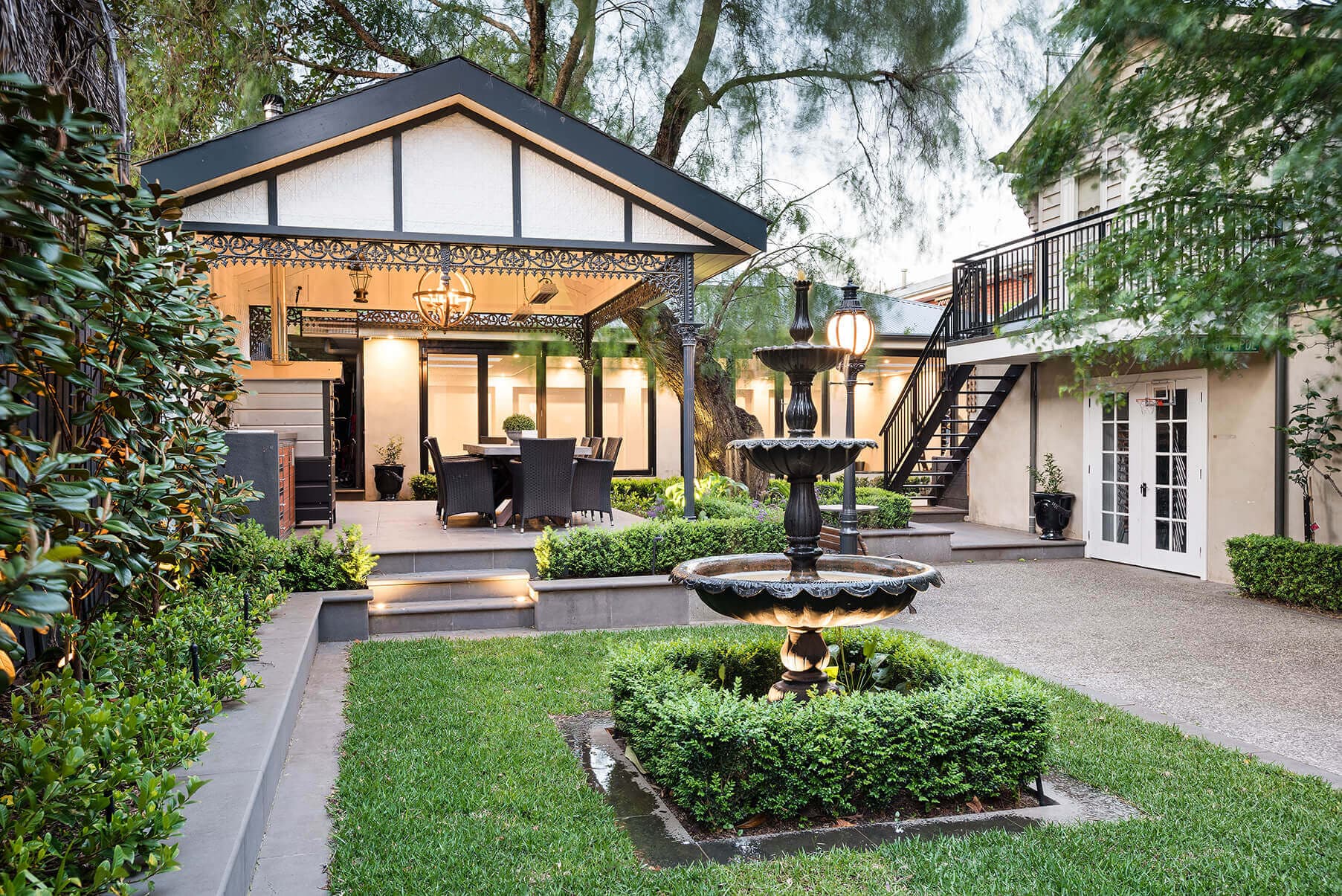 Residential landscape construction featuring a landscaped courtyard, water fountain and outdoor entertaining area