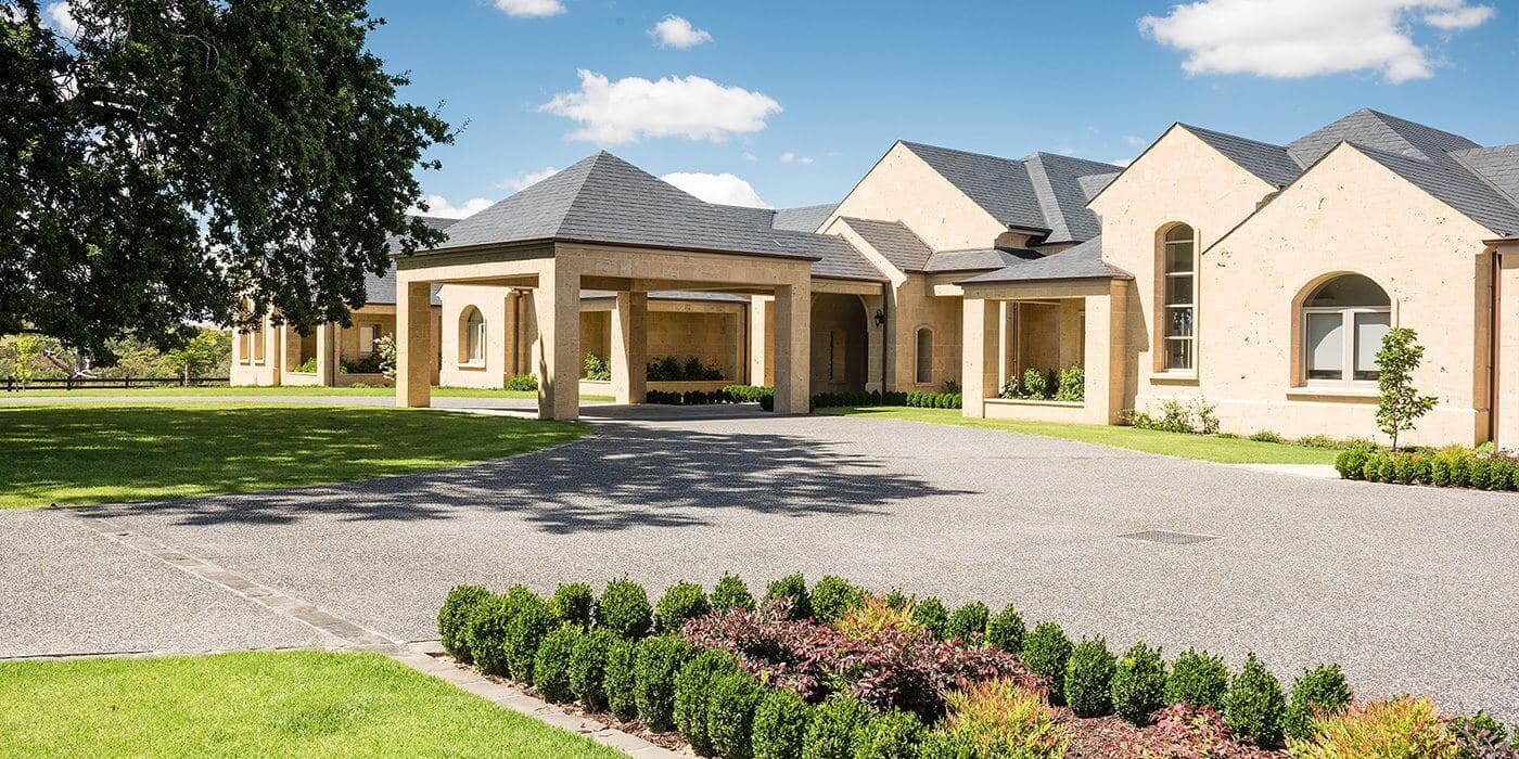 Landscaped front garden with lawn, planting and driveway at Narre Warren North home